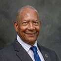 Alex English smiles at the camera 