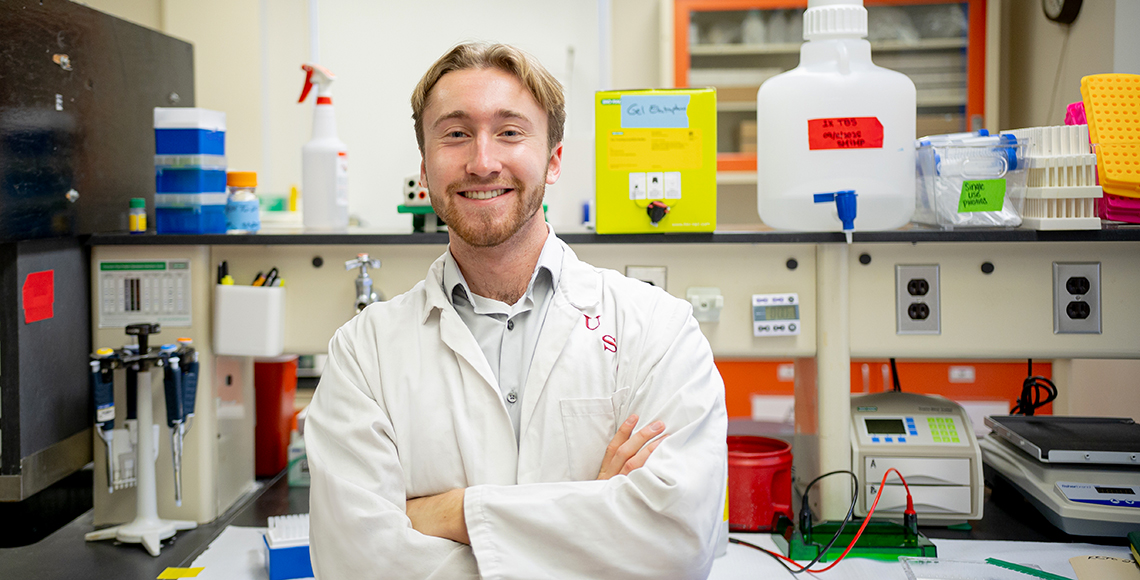 Michael Pitre in a white lab coat
