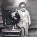 thumbnail of small African American child with a chicken