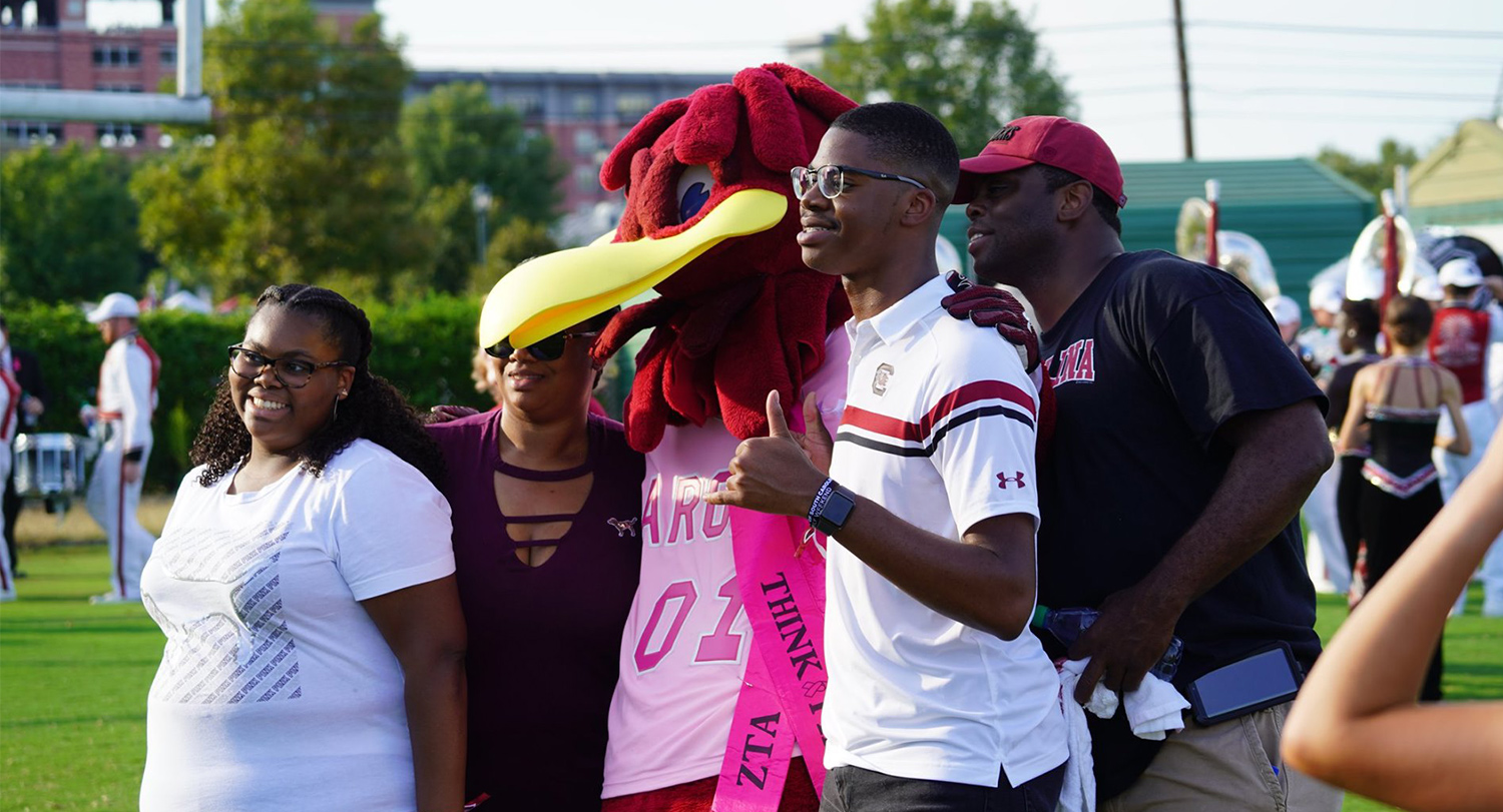 Family posing with Cocky at the Family Weekend Tailgate. 