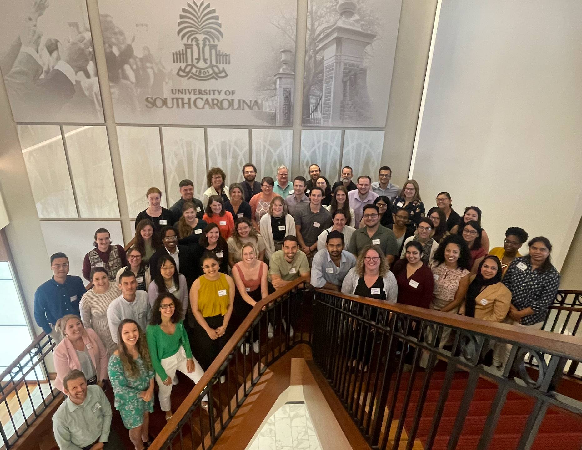 CAN faculty and trainees pose for a group picture on a staircase