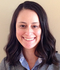 woman with blue shirt and gray sweater on