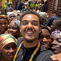 man smiling in a crowd of smiling people