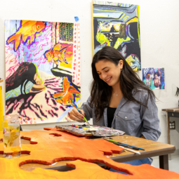 A graduate student painting in her studio.
