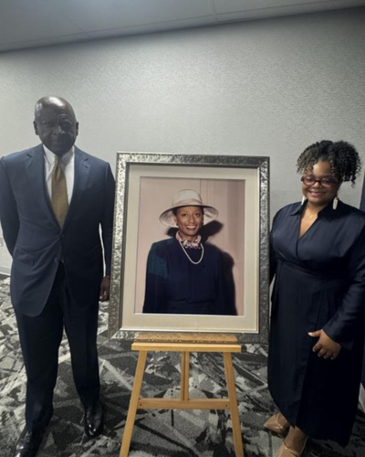 Gregory Glover and Shannon Eaves with a portrait of Adrenee Glover Freeman