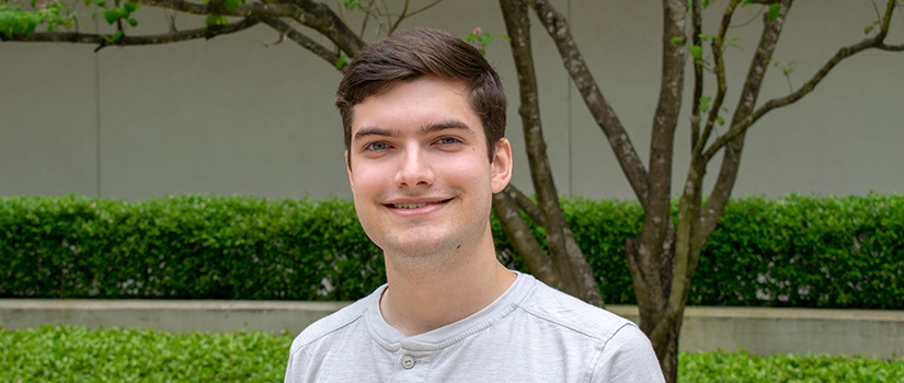 Josh Mulliken stands in Swearingen courtyard