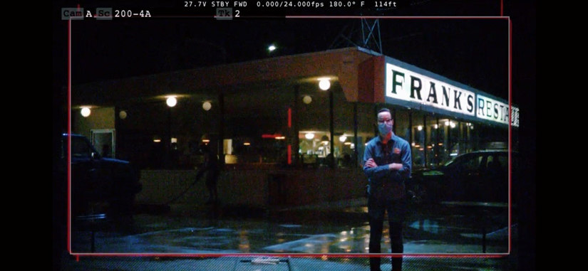 Screen capture of a camera monitor with Phillips outside, at night, in a restaurant parking lot.