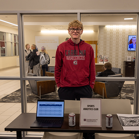 A member of the Sports Analytics Club poses at a student organization fair