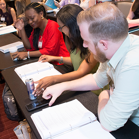 Students at desk with binders