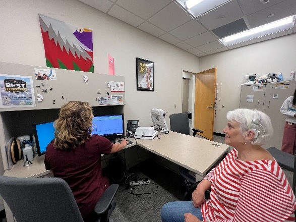 women talking at computer