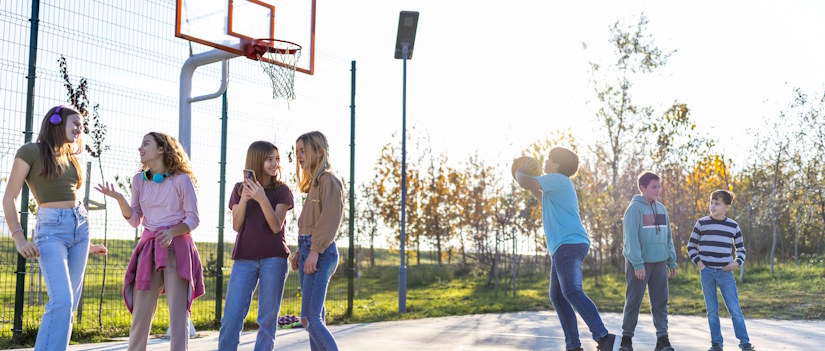 teens playing basketball
