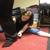 Alexis Doktor adjusts the hem of a uniform.