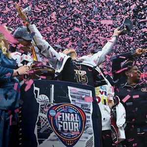 Dawn Staley throws her head back and hands out in celebration of the WBB National Championship.