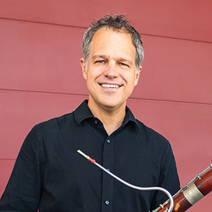 Smiling man holding a bassoon