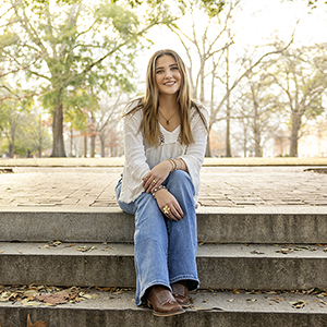 Teagan Thomas sits on steps near USC's historic horseshoe.